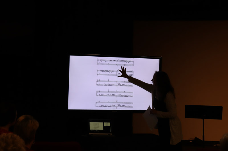 DVMTA presenter Zoe Simmons pointing at written music on screen