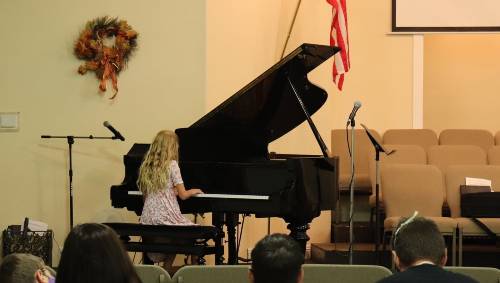 Piano student performing an original composition for DVMTA