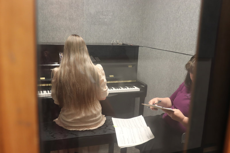 DVMTA teacher evaluating a piano student