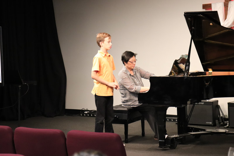 DVMTA Master class teacher on piano with student